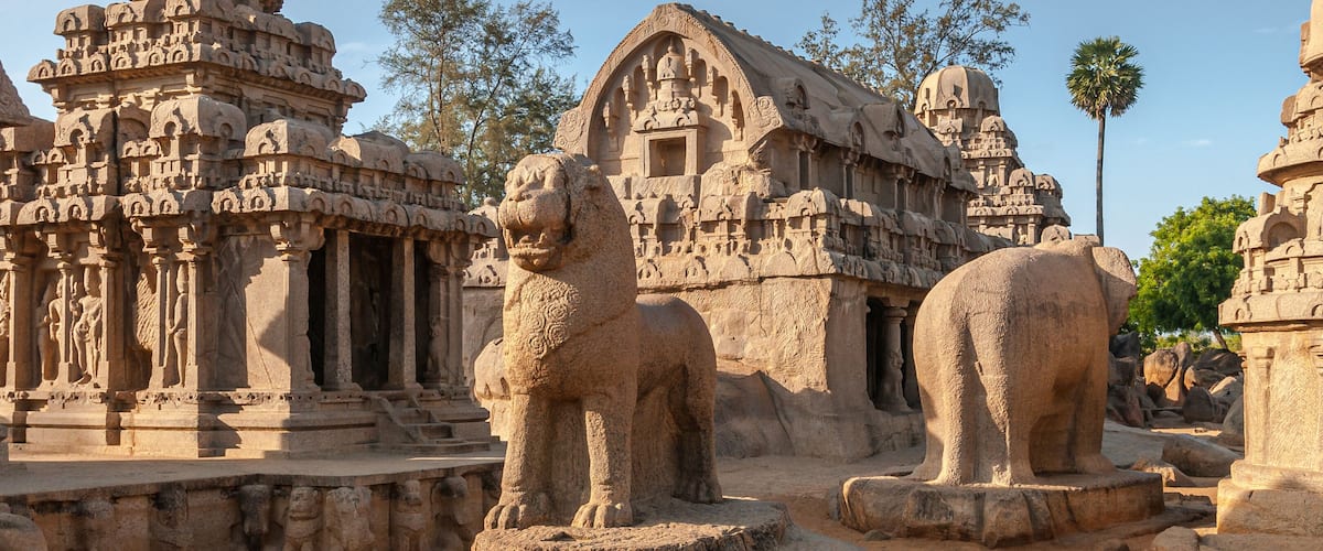 Ancient stone carvings and structures, including a prominent lion statue and intricate temple architecture.