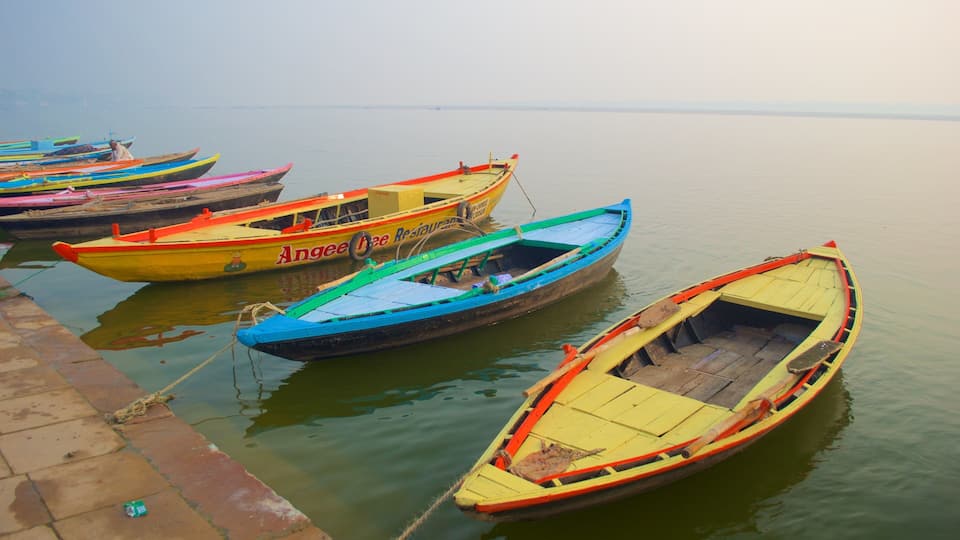A row of colorful boats docked at a calm body of water.
