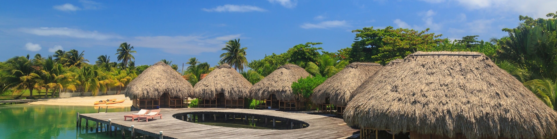 Stilted waterfront chalets and boardwalk, St. Georges Caye, Belize, Central America
