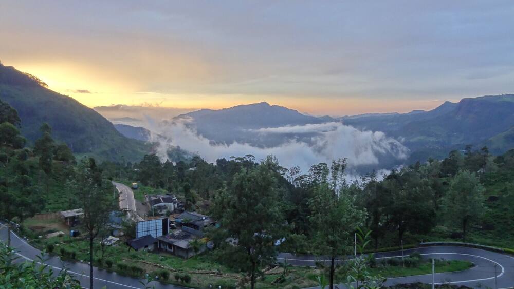 The road from Kandy to Nuwara Eliya is full of turns, deceptively long and passes some of the largest tea plantations in the world. Truth be told, driving anywhere in the hill country of Sri Lanka is an exercise in patience given that even short distances can take hours due to slow moving traffic, poor weather or less than desirable roads.
Better then to sit back and enjoy the ride while stopping for the occasional picture. (as we did for this cloudy sunset)