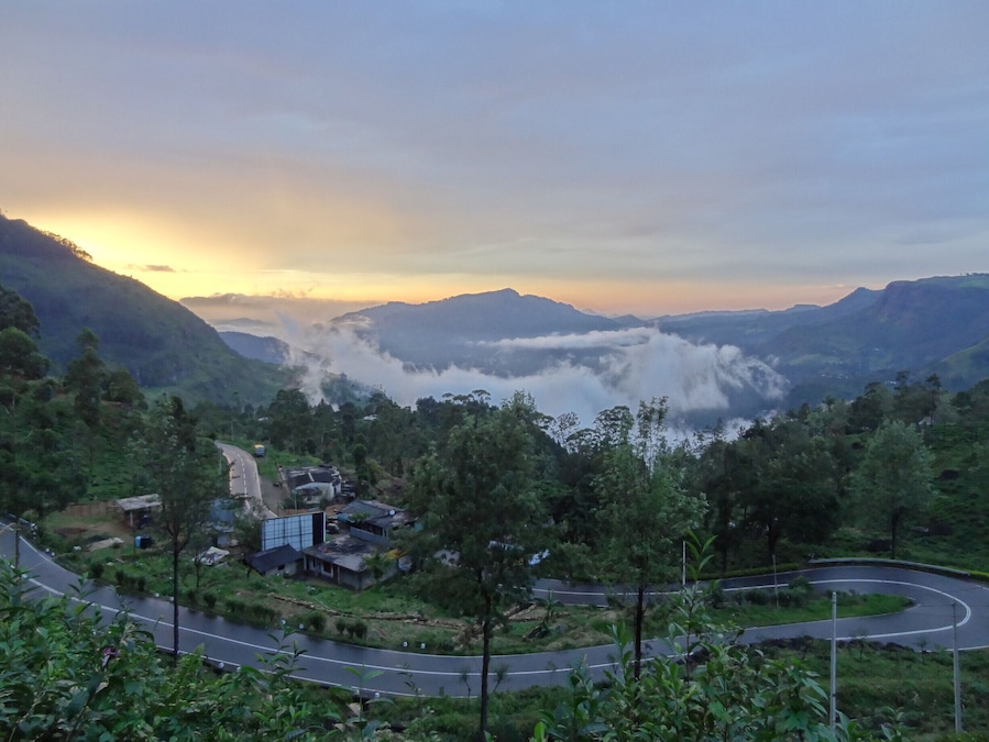 The road from Kandy to Nuwara Eliya is full of turns, deceptively long and passes some of the largest tea plantations in the world. Truth be told, driving anywhere in the hill country of Sri Lanka is an exercise in patience given that even short distances can take hours due to slow moving traffic, poor weather or less than desirable roads.
Better then to sit back and enjoy the ride while stopping for the occasional picture. (as we did for this cloudy sunset)