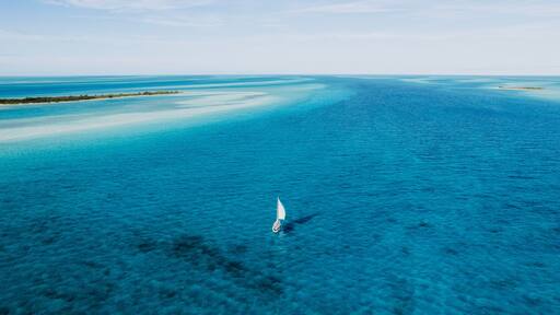 Aerial of Sailboat Sailing Between Islands in Turquoise Water