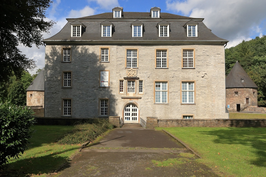 A large stone building with multiple windows and a central entrance.