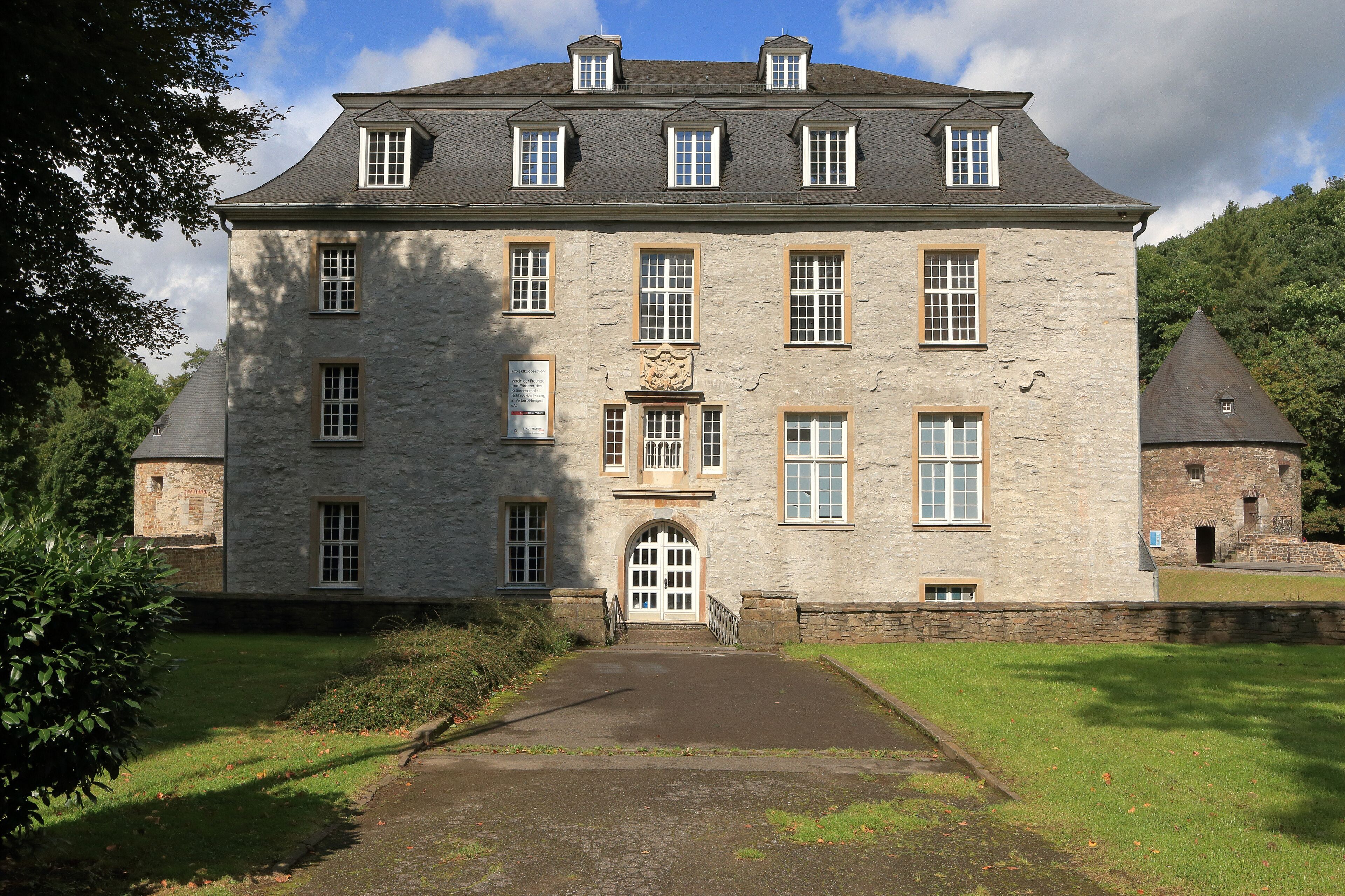 A large stone building with multiple windows and a central entrance.