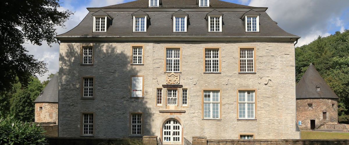 A large stone building with multiple windows and a central entrance.