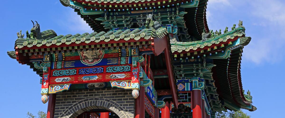 A traditional Chinese gate with intricate carvings and vibrant colors.