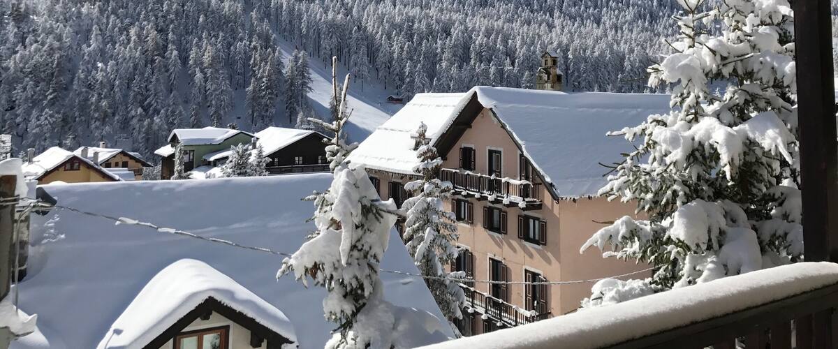 A snowy mountain landscape with houses and icicles.