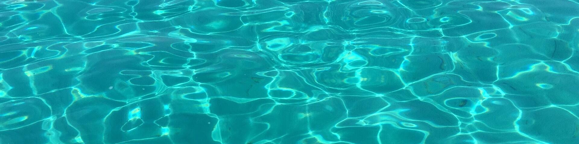 Clear, shallow water with visible ripples and patterns.