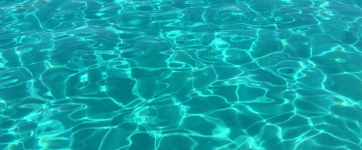 Clear, shallow water with visible ripples and patterns.