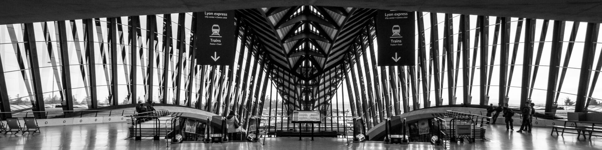 A modern train station with a high ceiling and large windows.