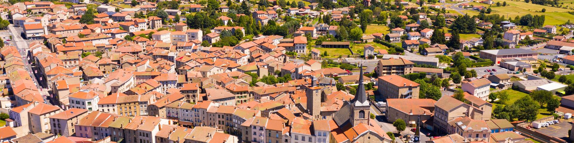 Flight over the city Craponne-sur-Arzon on summer day. France