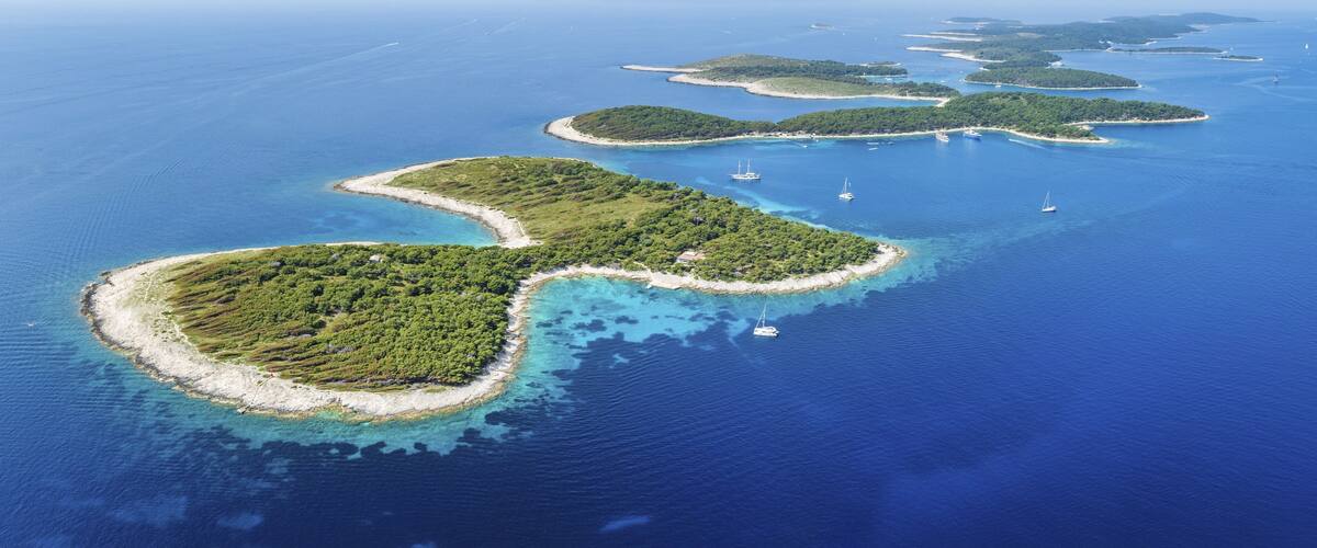 A chain of lush green islands surrounded by clear blue waters.