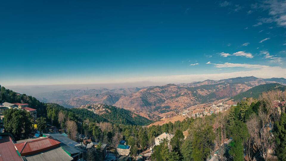 A mountainous landscape with a village nestled among the hills.