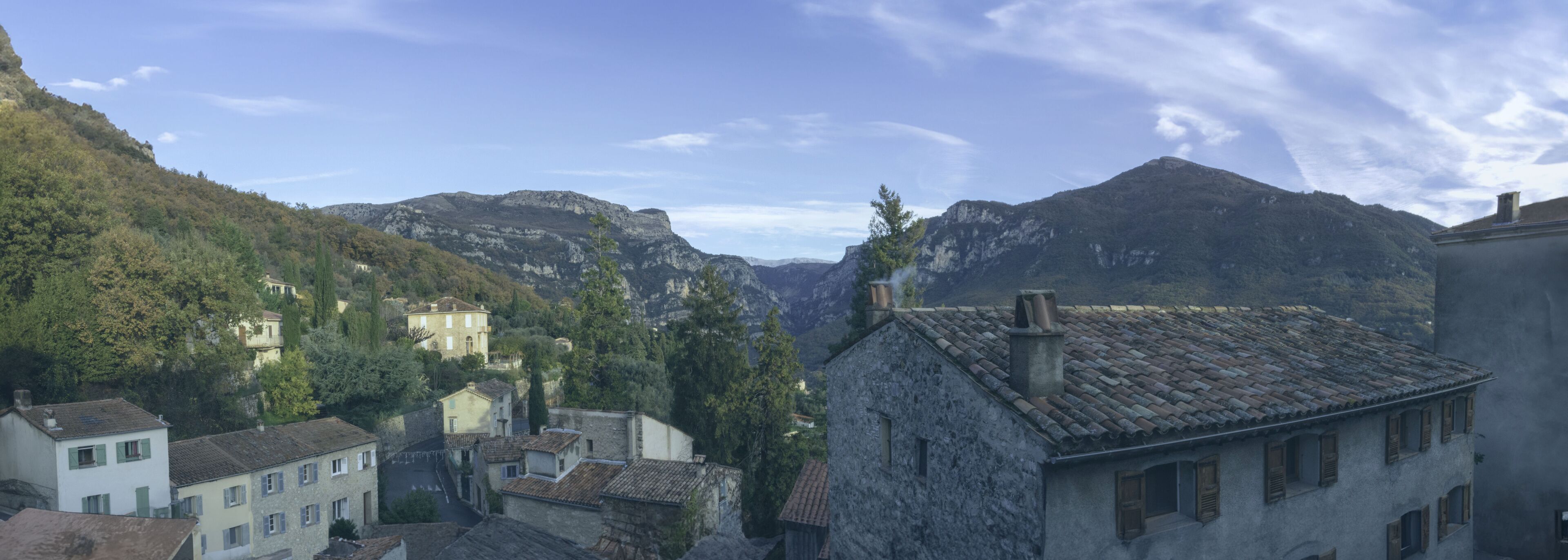 A mountainous village with stone buildings and a clear sky.