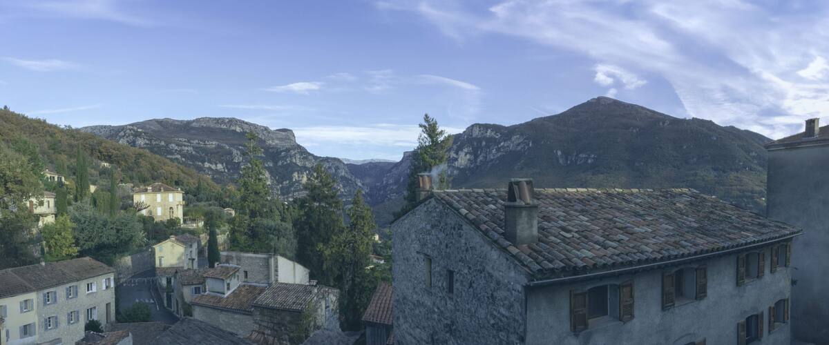 A mountainous village with stone buildings and a clear sky.