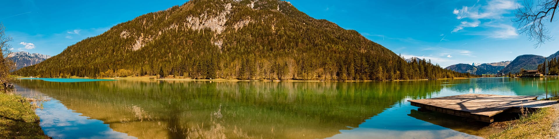 A mountain lake with a wooden dock.