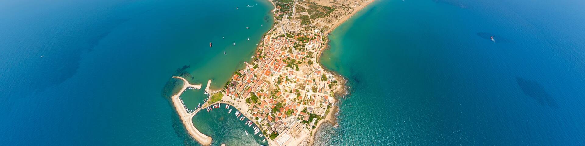 Side, Manavgat, Turkey. Wide aerial view of ancient city with Roman amphitheater, Agora, Temple of Apollo and Byzantine ruins on Mediterranean coast. Aerial view