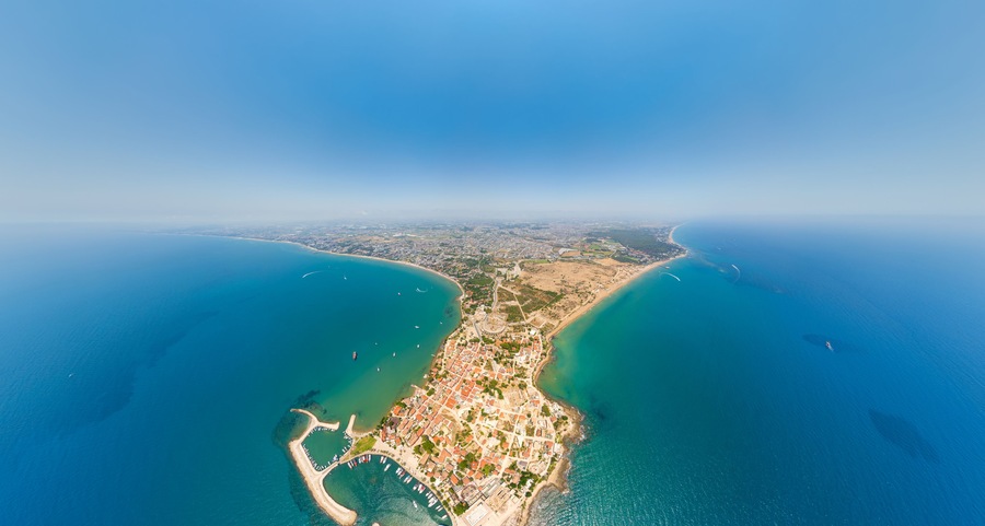 Side, Manavgat, Turkey. Wide aerial view of ancient city with Roman amphitheater, Agora, Temple of Apollo and Byzantine ruins on Mediterranean coast. Aerial view