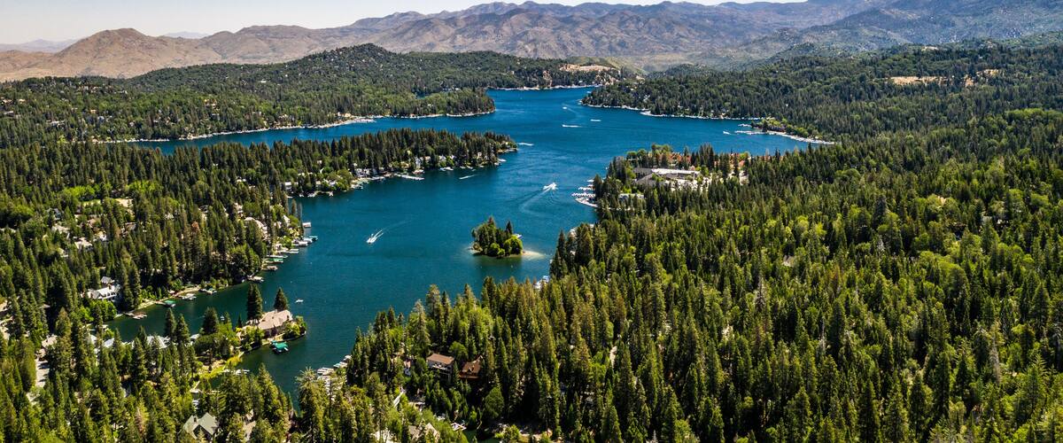 A lake surrounded by dense forests and mountains.