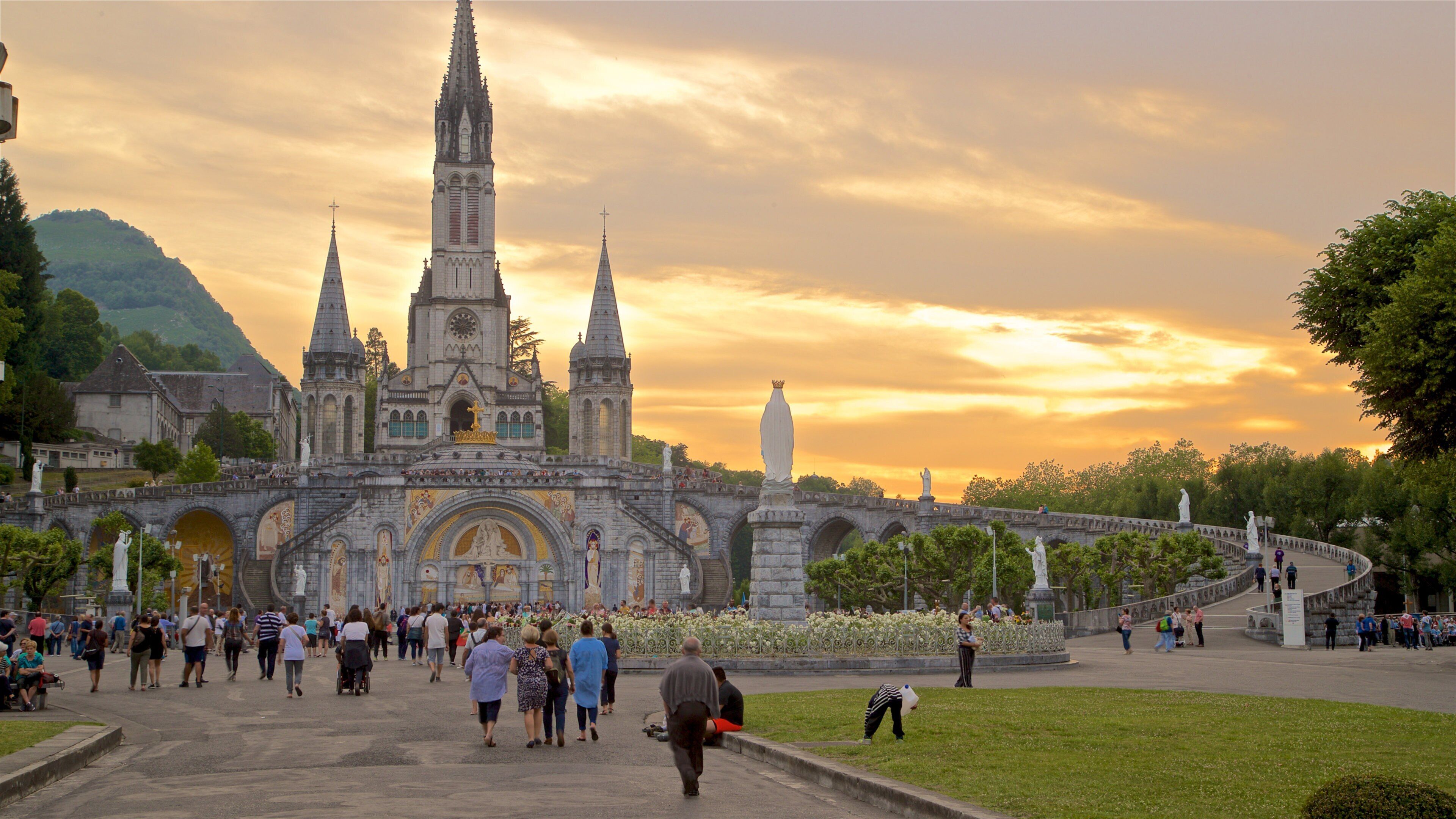 A historic cathedral with a tall spire and a bridge leading to it.
