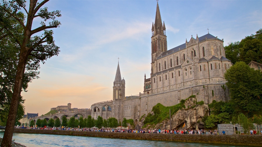 Lourdes - Tarbes featuring a sunset, a river or creek and a church or cathedral