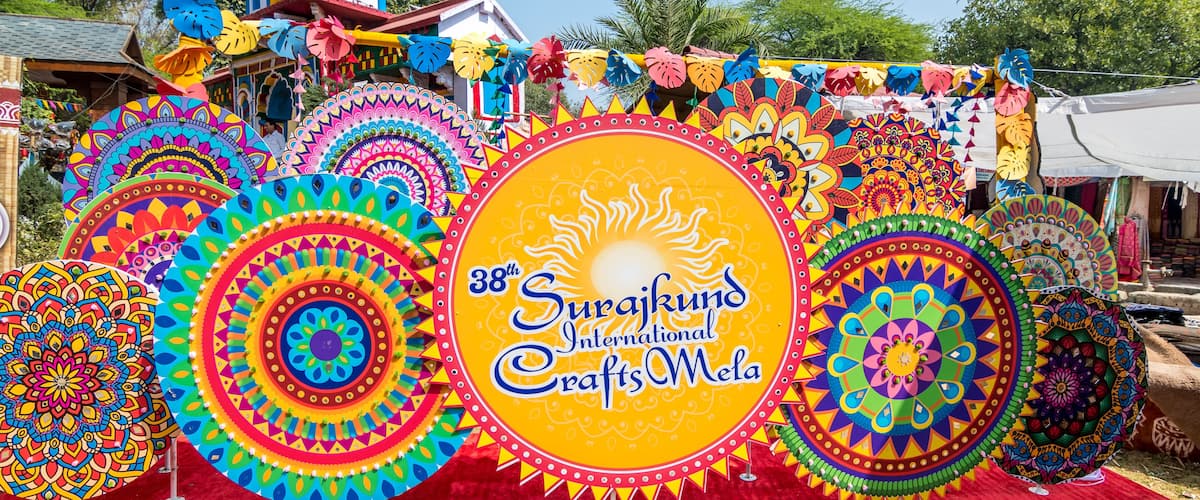 A vibrant display of colorful mandala art at the 38th Surajkund International Crafts Mela.