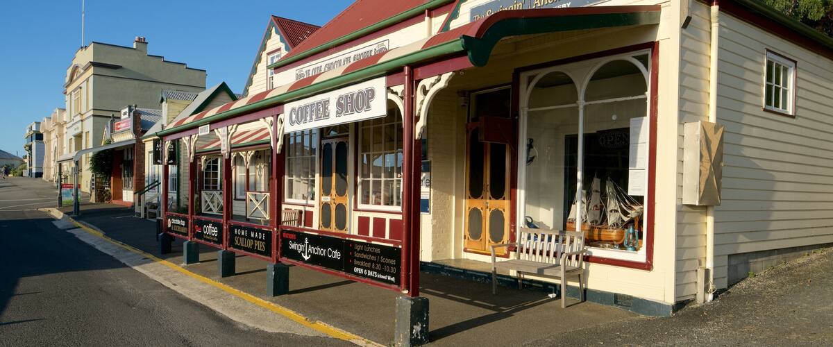 A row of vintage shops with a coffee shop, a scallop pie shop, and an anchor cafe.