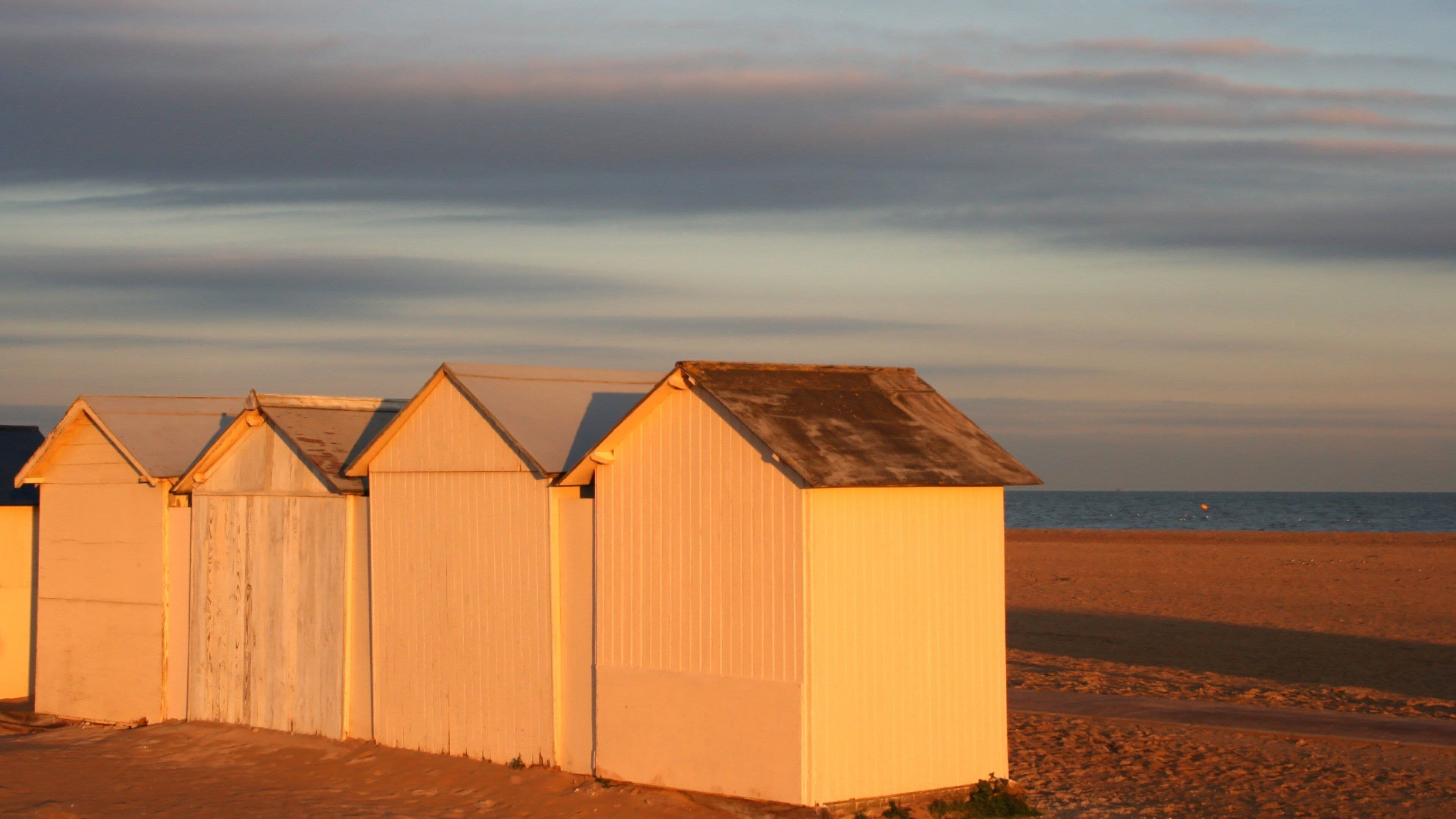Calvados showing a sunset and a sandy beach