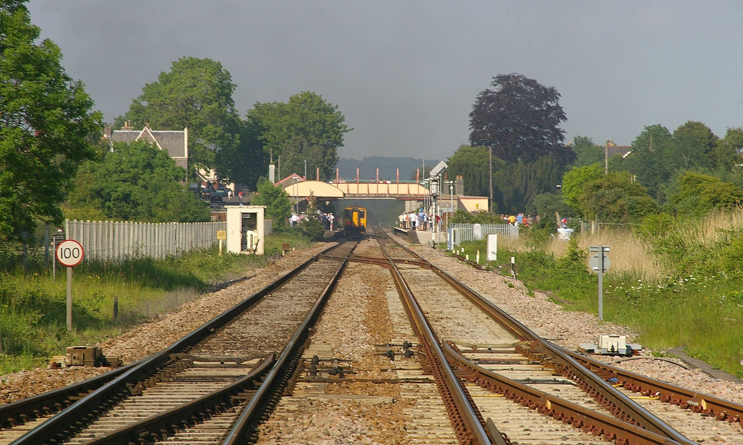 Looking east towards Yatton railway station from a level crossing. 150239 is leaving the station.
