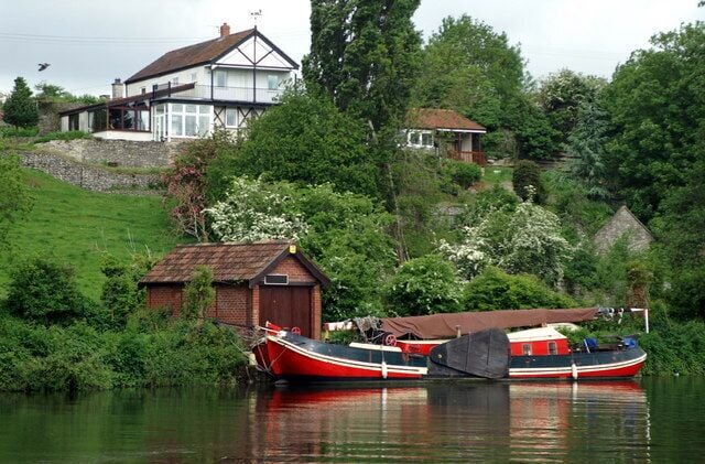 Saltford. House and Dutch barge on the left bank of the Avon below Saltford railway bridge