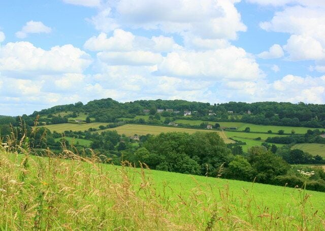 View from Shockerwick Lane Through a gap in the hedgerow on Shockerwick Lane we can look east up the valley of the By Brook toward Box. The hill to the right is Kings Down with its golf course and clinging to the near side we can see upper part of Kingsdown village.