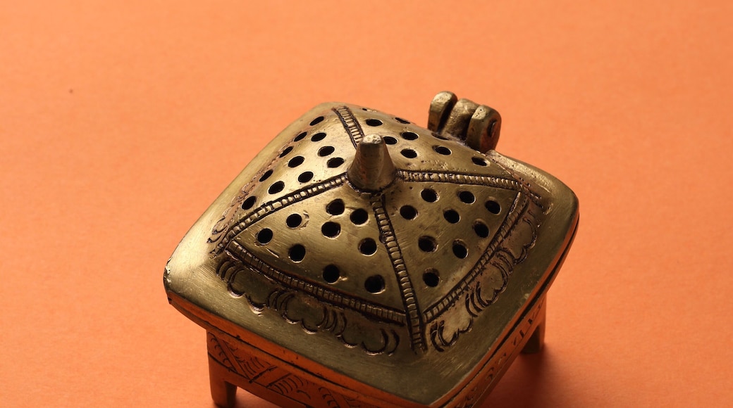 metal box made with brass on a orange base.