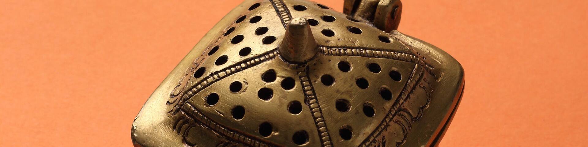 metal box made with brass on a orange base.
