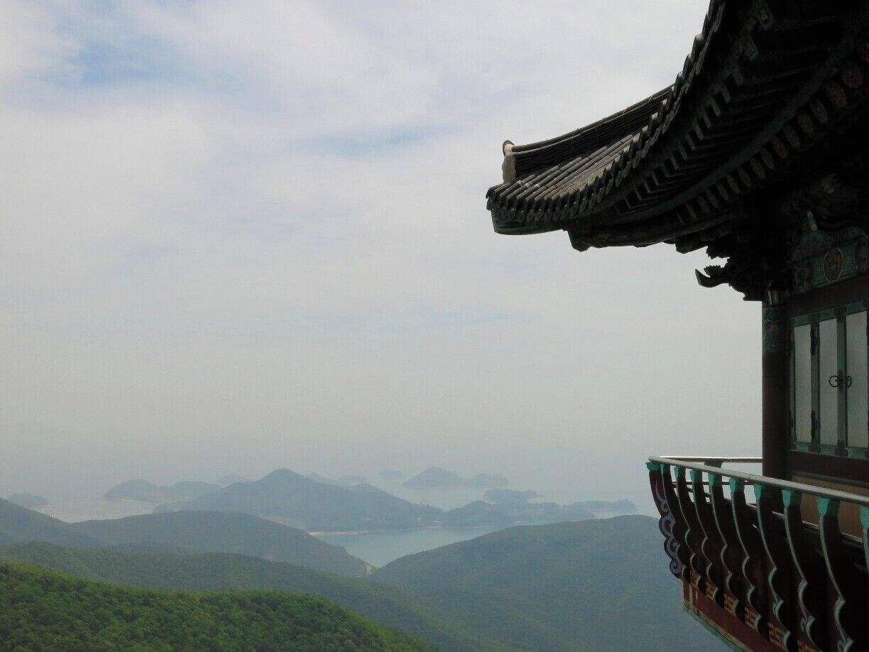 Geumsan is the tallest peak on Namhae island, Korea and has fantastic views over the islands, as well as this beautiful temple overlooking it all.

For more on Namhae and what to do there, check out my blog:
http://journey-count.com/kayaks-camping-chicken-namhae/