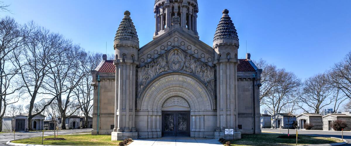 A large, ornate building with a pointed roof and two smaller towers.
