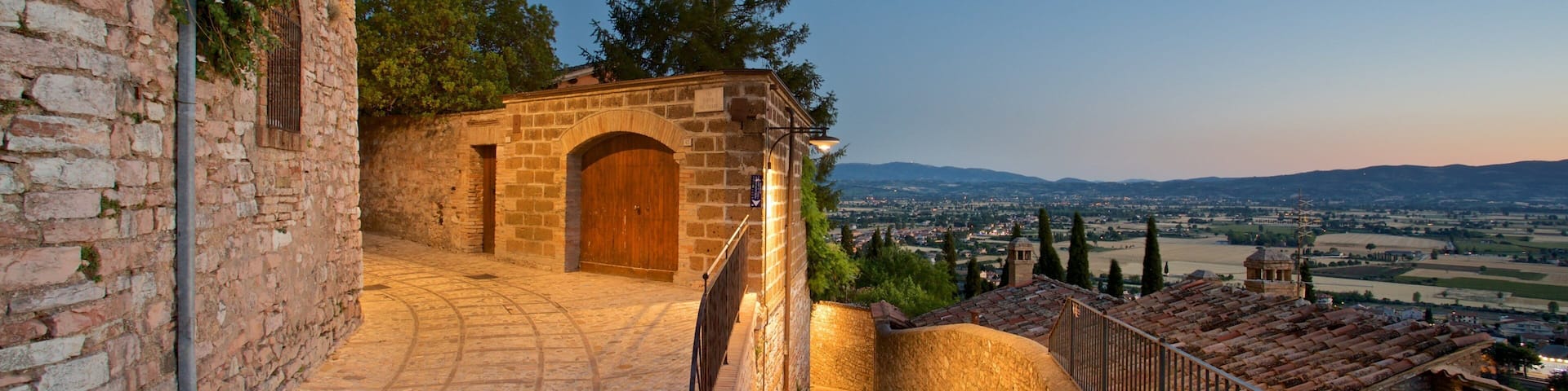 Spello showing a small town or village and night scenes
