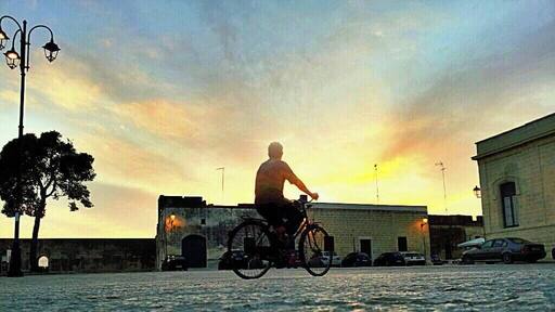 Biking in the sunset at Acaia, an italian village in Puglia region.