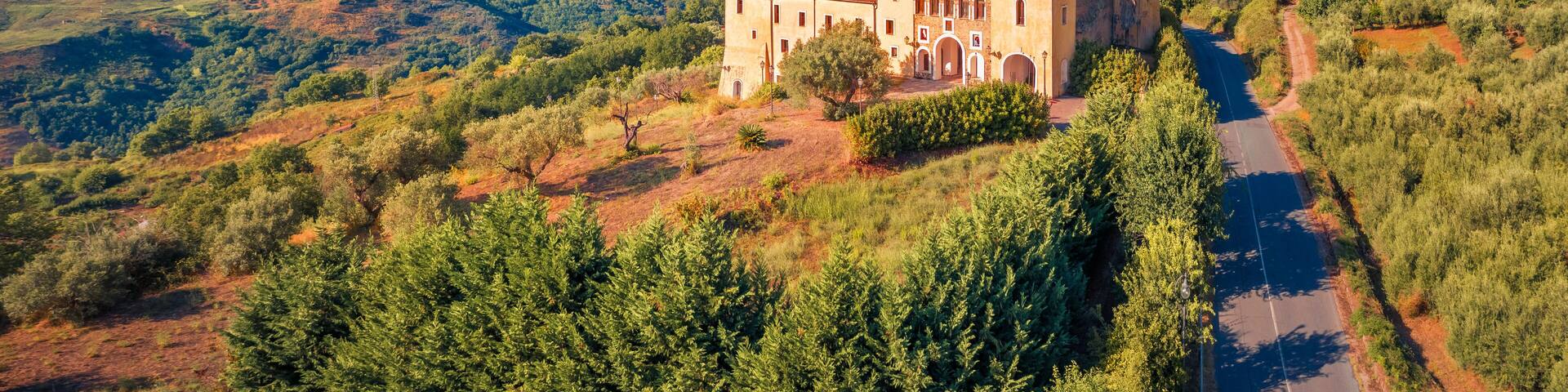 Amazing view from flying drone of typical Italian church, Bonifati village location, Province of Cosenza. Picturesque summer scene of mountains in Italy, Europe. Traveling concept background..
