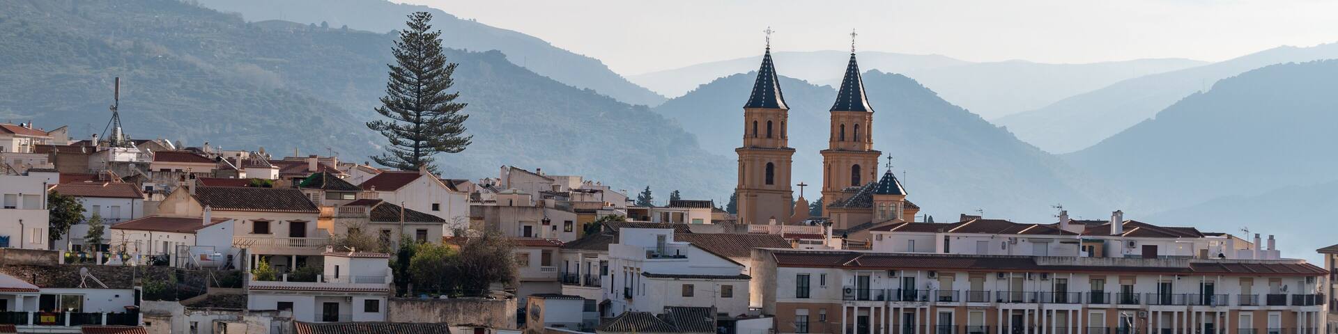 View of the houses and the two bell towers of the church of Orgiva in the Alpujarra of Granada (Spain)