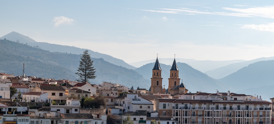 View of the houses and the two bell towers of the church of Orgiva in the Alpujarra of Granada (Spain)