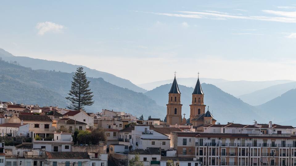 View of the houses and the two bell towers of the church of Orgiva in the Alpujarra of Granada (Spain)