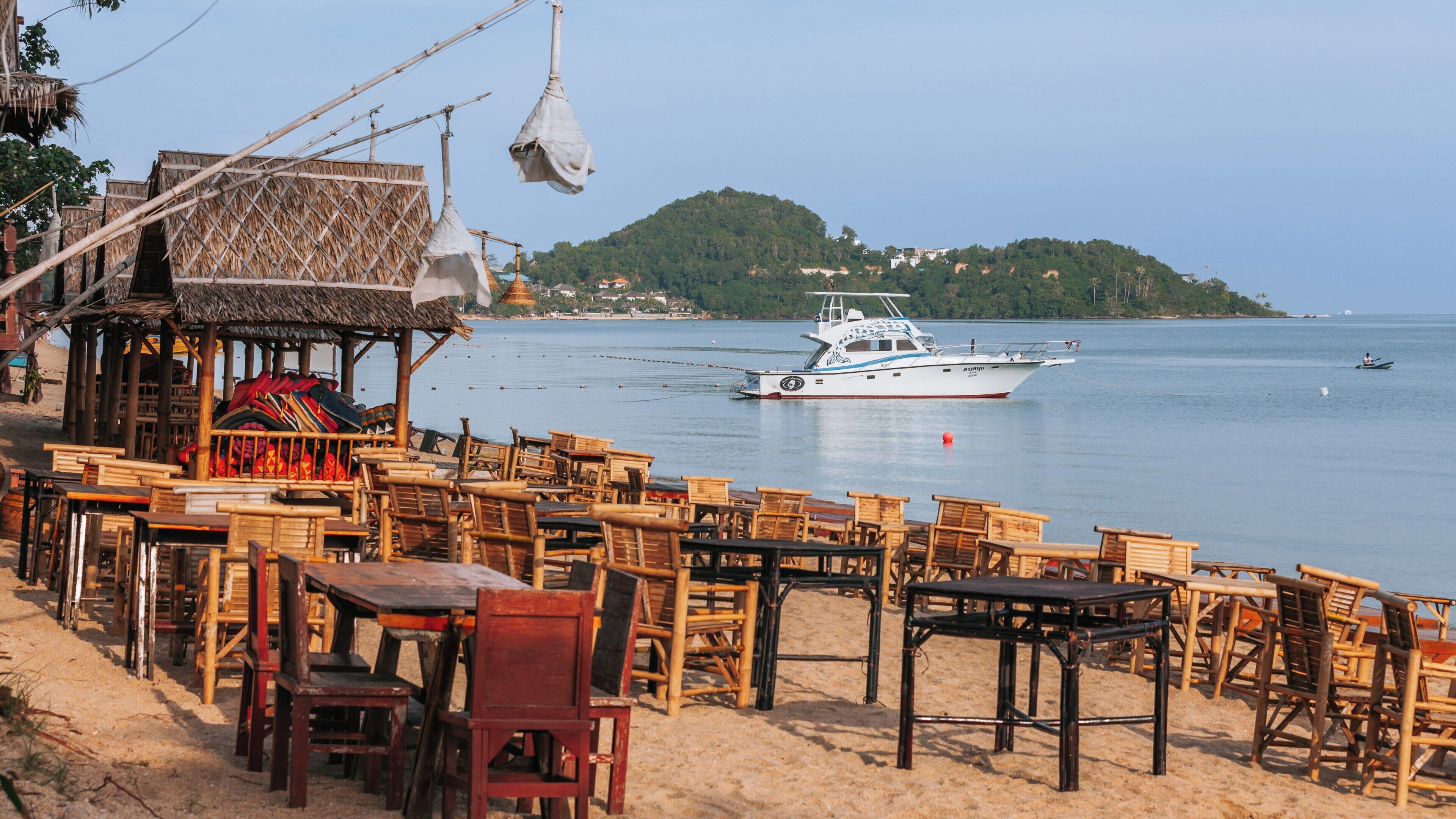 Relaxing day at Bo Phut Beach, Koh Samui, with beautiful views of the ocean and boats under a clear sky in Surat Thani Province, Thailand