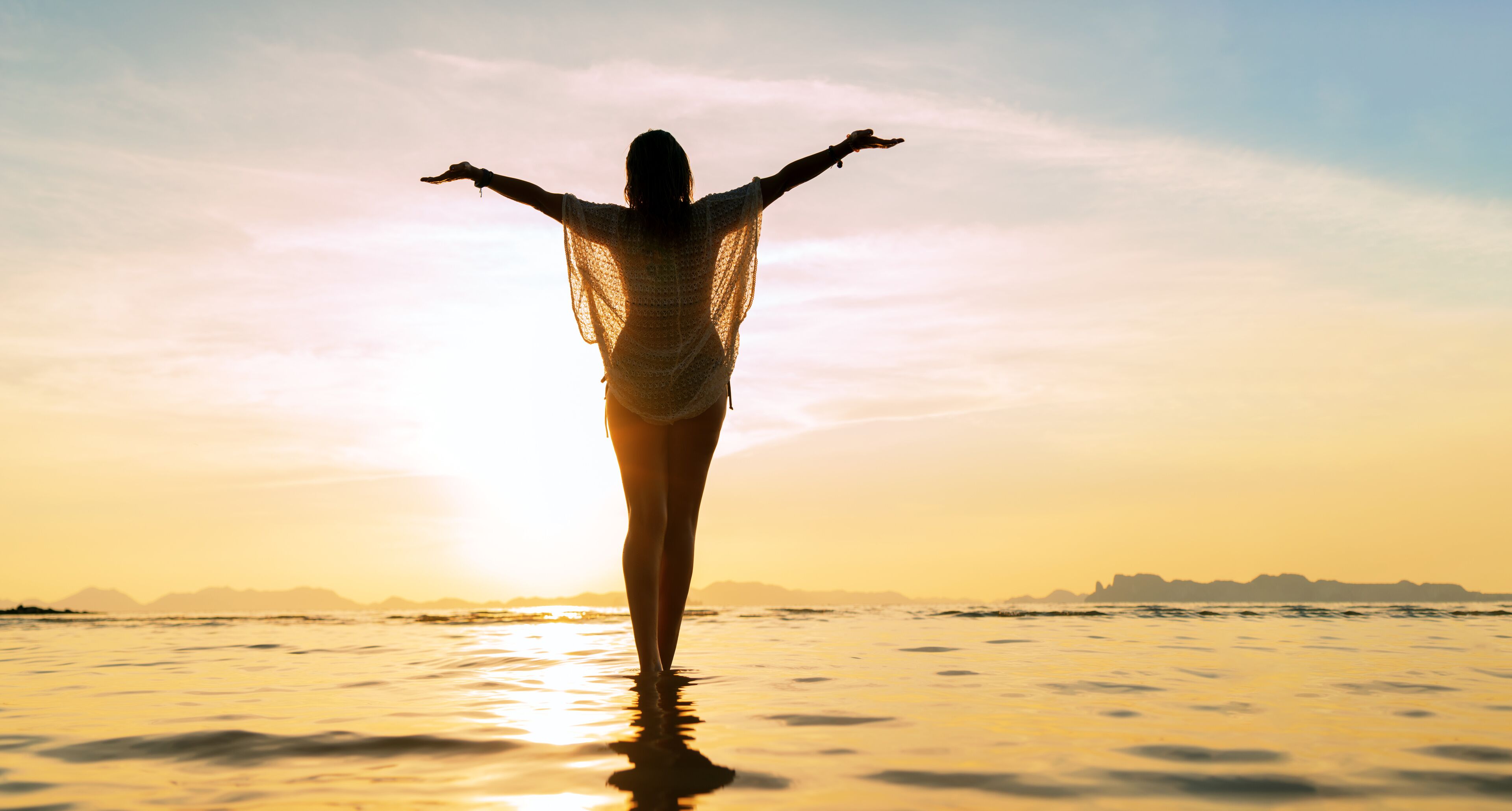 Silhouette of a Beautiful Woman at the beach in Thailand at sunset
