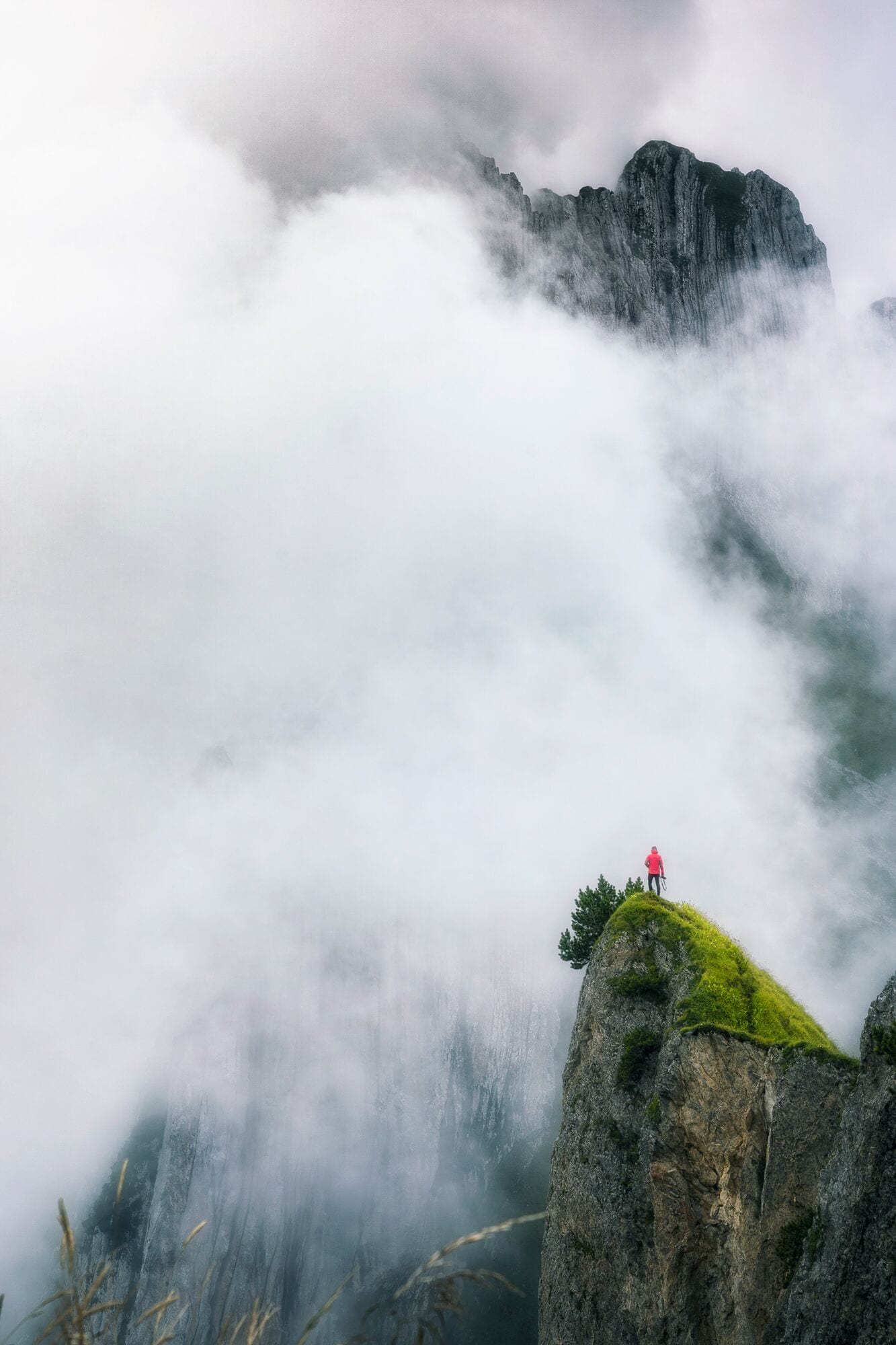 We took the first cable car up at 7am, and after a short 1h walk arrived to this place. It was changing from complete white out to clear sky for a minute, and then getting white again for an hour. Nevertheless, I took quite a lot of photos in this weather, as it felt so magical with the mist partially covering this beautiful rock formation. To get to this point of view, we had to walk along exposed ridges on a narrow path, in very wet and knee deep grass. Definitely, an #adventure worth waking up for. 