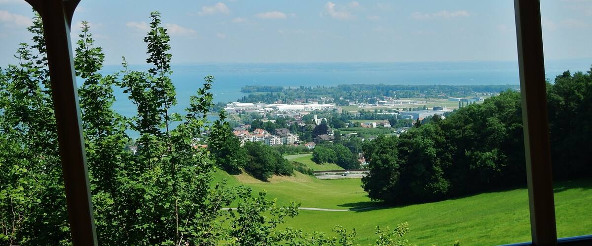 A coastal town with a view of the sea and a green landscape.