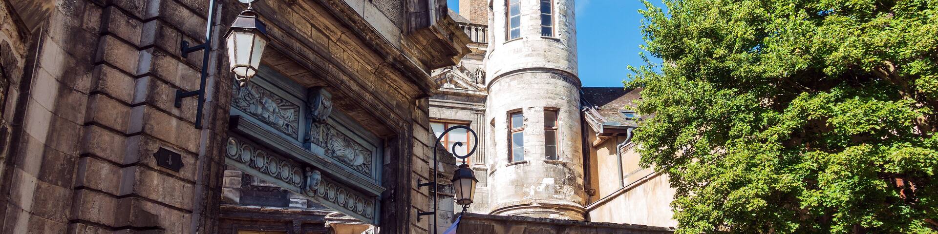 A historic building with ornate architecture, a tower, and a flag.