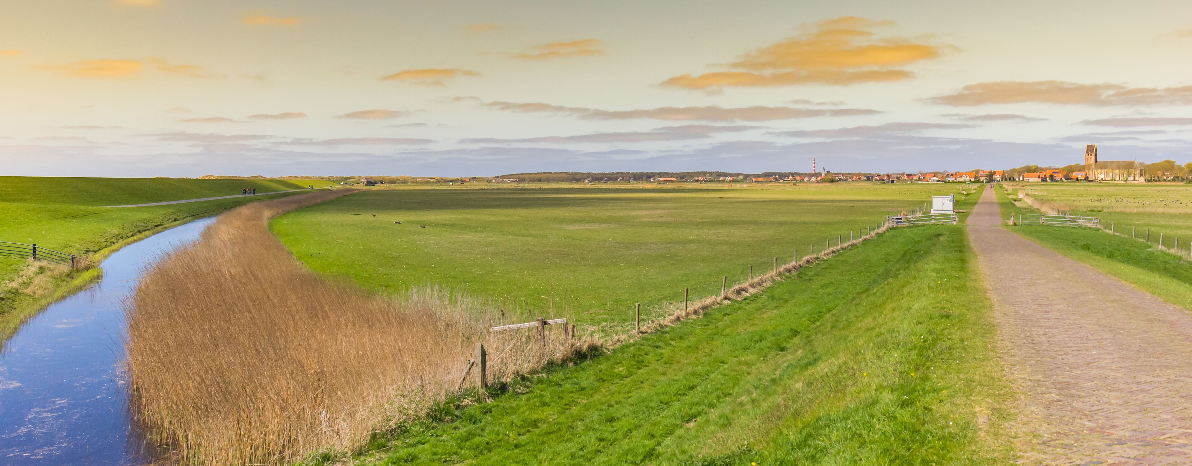 Panorama of sunset over the landscape and Hollum village in Ameland, Netherlands