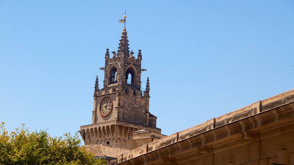 A historic clock tower with intricate architecture and a clear blue sky.