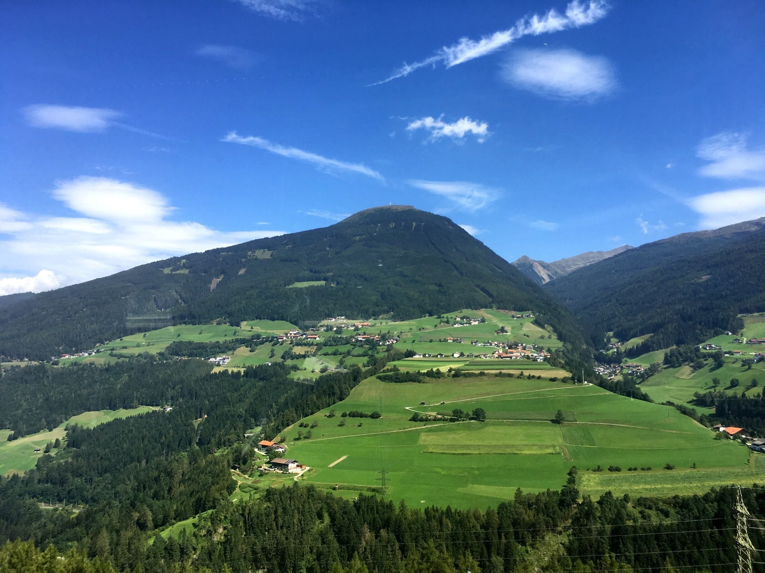 A mountainous landscape with a village nestled in the valley.