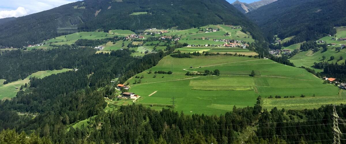 A mountainous landscape with a village nestled in the valley.